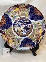 Full view of the large round Imariware platter showing the Oriental house pattern with birds and floral motifs.