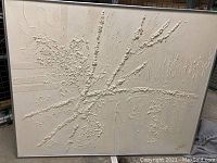 Full front view of large square textured painting in silver-tone metal frame