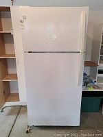 Front view of white Kenmore fridge freezer unit, showing doors closed and overall external appearance.
