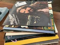 Stack of ten vinyl LP records with Bob Seger and the Silver Bullet Band 'Stranger in Town' album on top, others underneath, showing album covers.