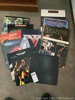 Overview photo showing all twelve LP record album covers laid out on a floor.