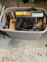 Plastic tub containing American Flyer S gauge track sections, transformer and components
