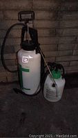 Photo showing two pressurized garden sprayers side by side, one large Mastercraft and one smaller Spray Doc with green top