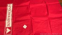Photo of red fabric cover with 'Mastercraft' branding and small label with '39' on it.