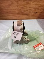 Side view of the mounting assembly showing metal body and rubber bushing with Honda part label.