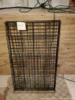 Folded black metal large dog crate