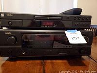 Front view of Denon DVD player stacked on top of Denon AV receiver with visible model buttons and display.