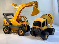 Yellow toy excavator truck and yellow toy cement mixer truck side by side showing general condition and design.