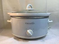 White Crock-Pot slow cooker with model number and control knob visible.