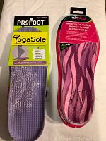 Pair of Yoga Sole and AirPlus insoles in packaging showing front view of both with Profoot branding