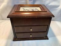 Front view of the wooden jewelry box showing two drawers with gold-tone knobs.