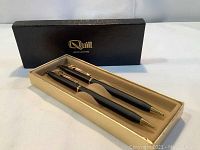 Set of vintage Quill ballpoint pen and mechanical pencil in original box with gold Quill logo on black lid.