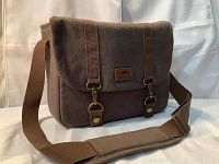 Front angled view of brown New Roots 73 flannel camera messenger bag with shoulder strap visible.