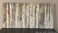 Front view of large horizontal canvas painting depicting birch tree trunks on a neutral background