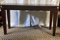 Full view of the wooden console table showing the overall design and finish.