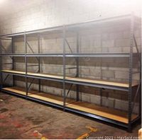 Three‐section adjustable racking system against cinderblock wall