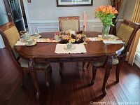 Oval dining table set up with runner and decor