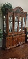 Full view of both china cabinet and buffet showing front and carved details