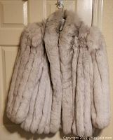 Front view of the silver blue fox fur jacket showing fluffy fur and shawl collar.