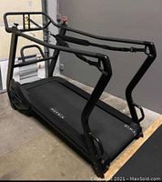 Front perspective view showing curved deck, side rails and harness straps attached to frame