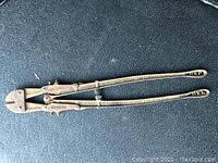 Full view of the vintage HK Porter bolt cutter with long handles and cutting jaws.