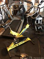 Side view of yellow X-frame bike in home gym