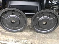 Pair of 35 lb York Olympic weight plates side by side showing edges and overall finish