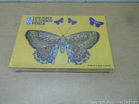 Front of sealed puzzle box showing colorful butterfly image and puzzle piece count