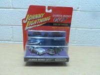 Front view of Johnny Lightning James Bond 007 Goldfinger car set in original packaging fixed to a red and black branded backing card.