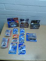 Lot arranged on table showing all 11 toy motorcycles and rider figure, all mostly in original packaging with visible brand logos and collector series.