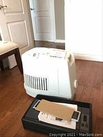 White Noa brand humidifier placed on floor with manual on top