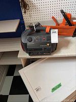 Powerpack 300 emergency power source unit on table with cord and nearby tools, showing front view and controls.