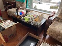 Photo showing the full coffee table in living room setting with items on top and underneath visible, highlighting size and style.