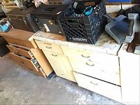 Wooden and metal toolboxes with hardware and tools on workbench
