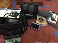 Full view of Garmin StreetPilot units with bags, pens, Dazzle reader, and GPS units