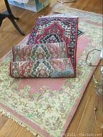 Image showing a pair of smaller 3x5 feet rugs with traditional pattern, placed on floral mat