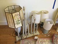 Overview of six lamps including floral shade lamp, candle-style multi-bulb lamp, and lamps with missing shades.