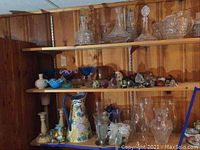 Wide shelf view showing mixed glass and ceramic items