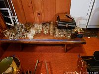 Full front view of the wooden coffee table in basement setting with items on top