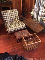 All four items displayed: coffee table, lounge chair, magazine rack, and footstool