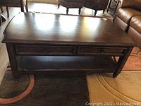 Top view of the dark wood sofa table showing the smooth surface and two drawers.