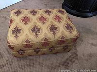 Plush foot stool showing side and top angled view.