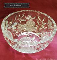 10 inch crystal bowl with etched butterfly and floral design and scalloped edge on red fabric background