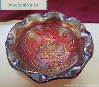 Top-down photo of the iridescent carnival glass rose bowl highlighting the detailed embossed floral pattern and scalloped edge.