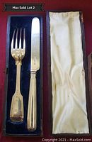 Knife and fork set in vintage fabric lined case with blue velvet base.