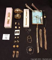Overhead shot showing all items: watches, bracelets, brooches, earrings, rings, and necklaces.