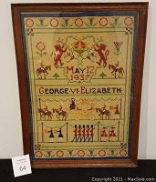 Front view of framed needlework embroidery showing colorful decorative motifs, date May 12 1937, and George & Elizabeth text.