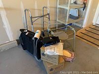 Full view of medical supplies including folding bedside commode, walker, black medical bag, knee braces, and boxes of sterile bandages
