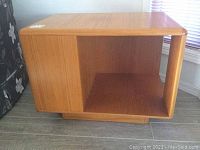 Front view of rectangular wooden table with open side cubby and vertical divider