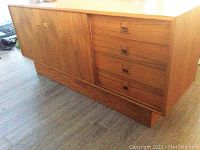 Front view showing four drawers on right and sliding door on left